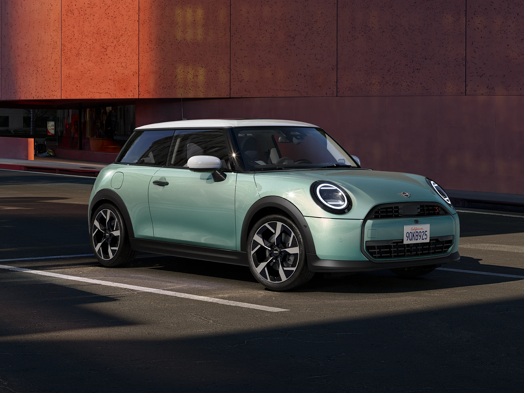 מבט מצד ימין קדמי על ה-MINI Cooper‏ בצבע ירוק Ocean Wave Green וגג לבן.