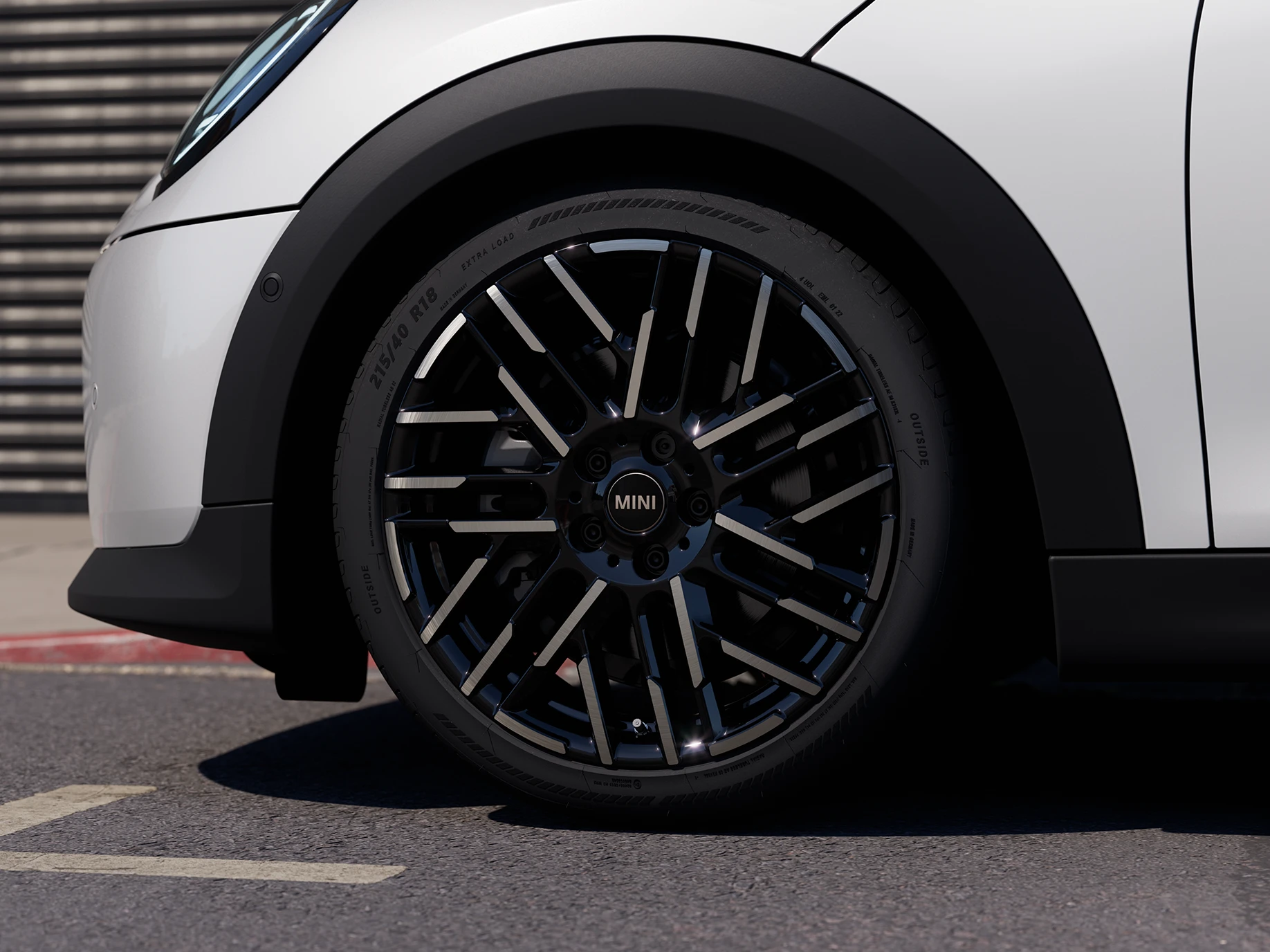 צילום מקרוב של ה-MINI Cooper‏ 5 דלתות בצבע לבן Nanuq White עם חישוקי Night Flash בשני גוונים.